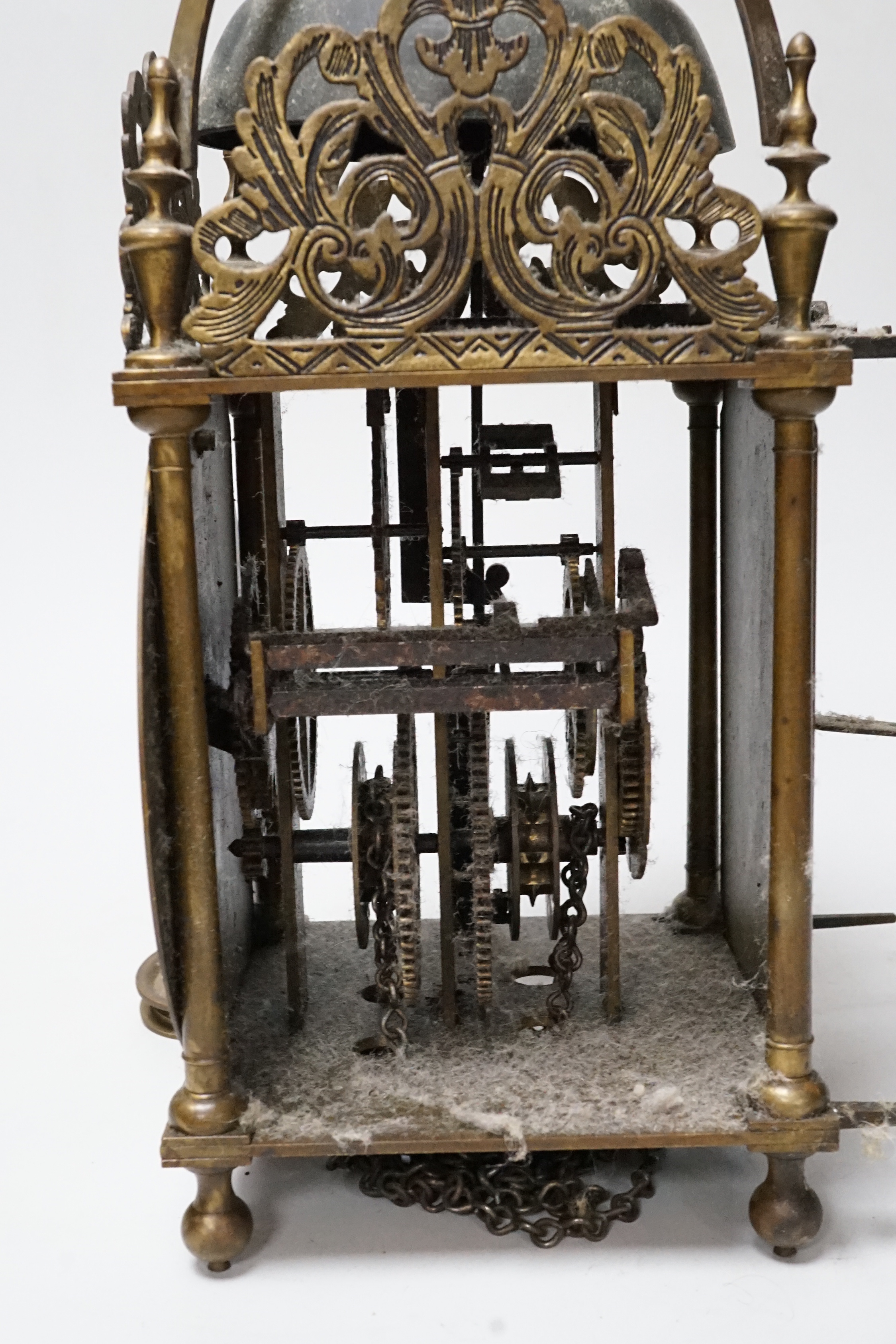 An English brass lantern clock with four branch finial decoration signed Tho Moore of Ipswich, 36cm tall